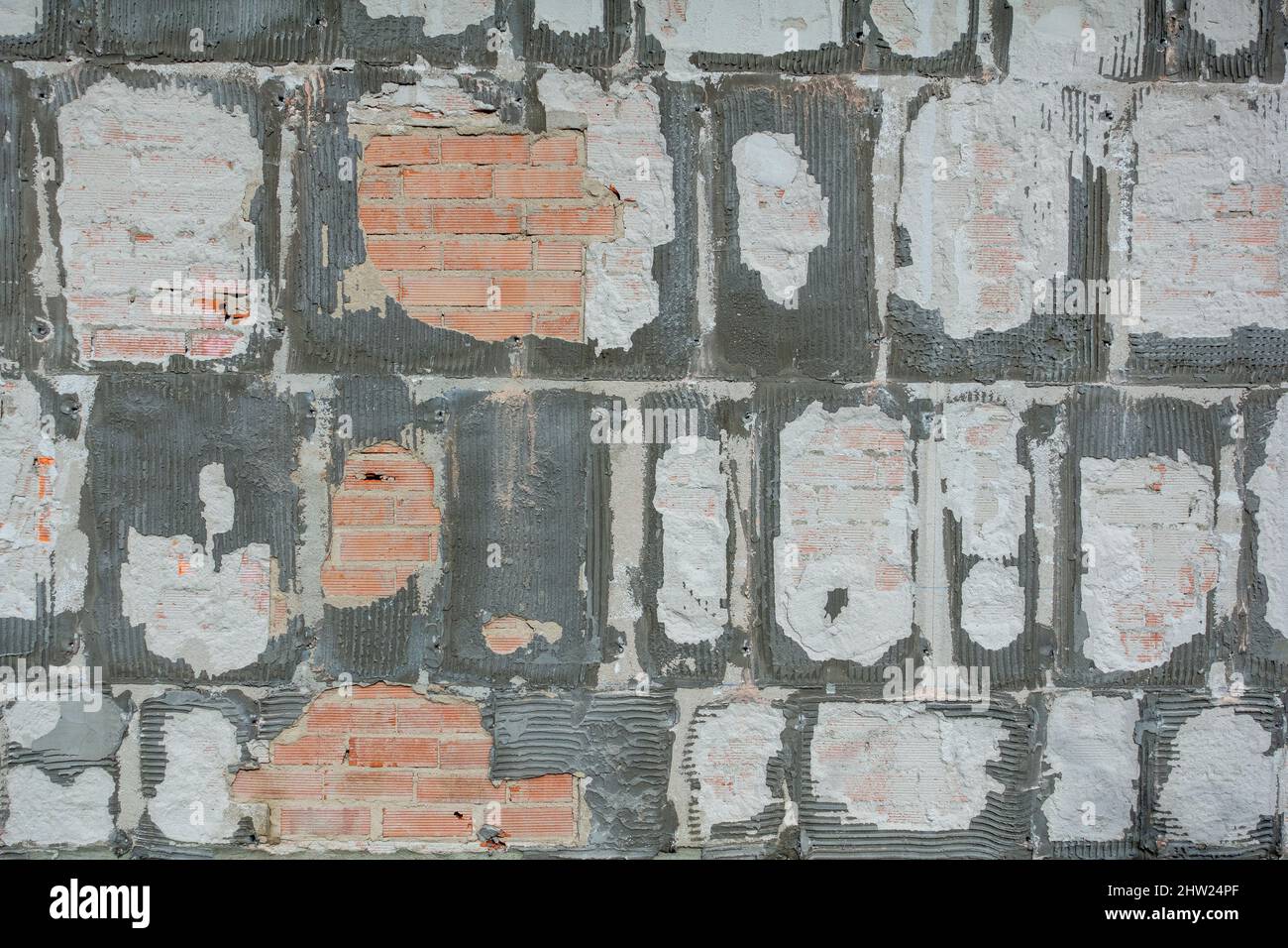 Wall surface after removing ceramic tiles Stock Photo Alamy