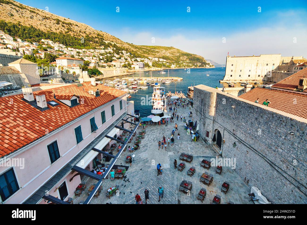 Dubrovnik, Croatia, Europe - August 2021: the old medieval port by the city walls. Dubrovnik historic city of Croatia in Dalmatia. UNESCO Venetian Stock Photo