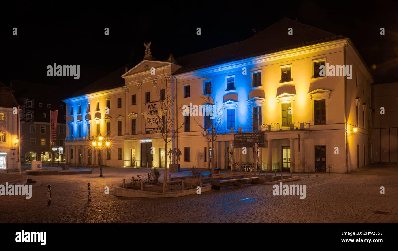 The front of the Stadttheater on the Bismarckplatz in Regensburg illuminated in the Ukrainian national ensign colors blue and yellow as sign of solida Stock Photo