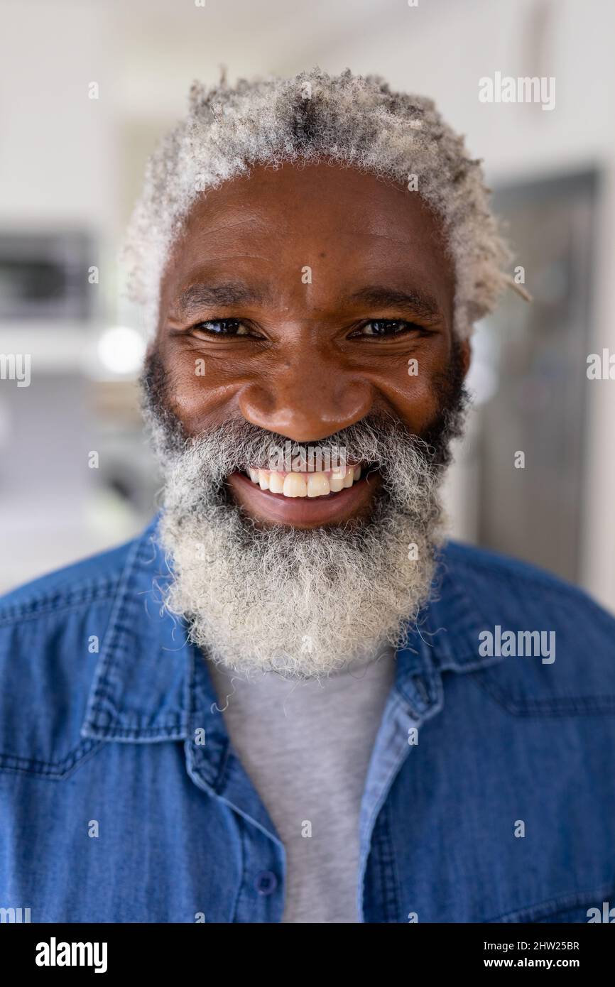 Close-up portrait of smiling african american senior man with white hair and beard at home Stock Photo