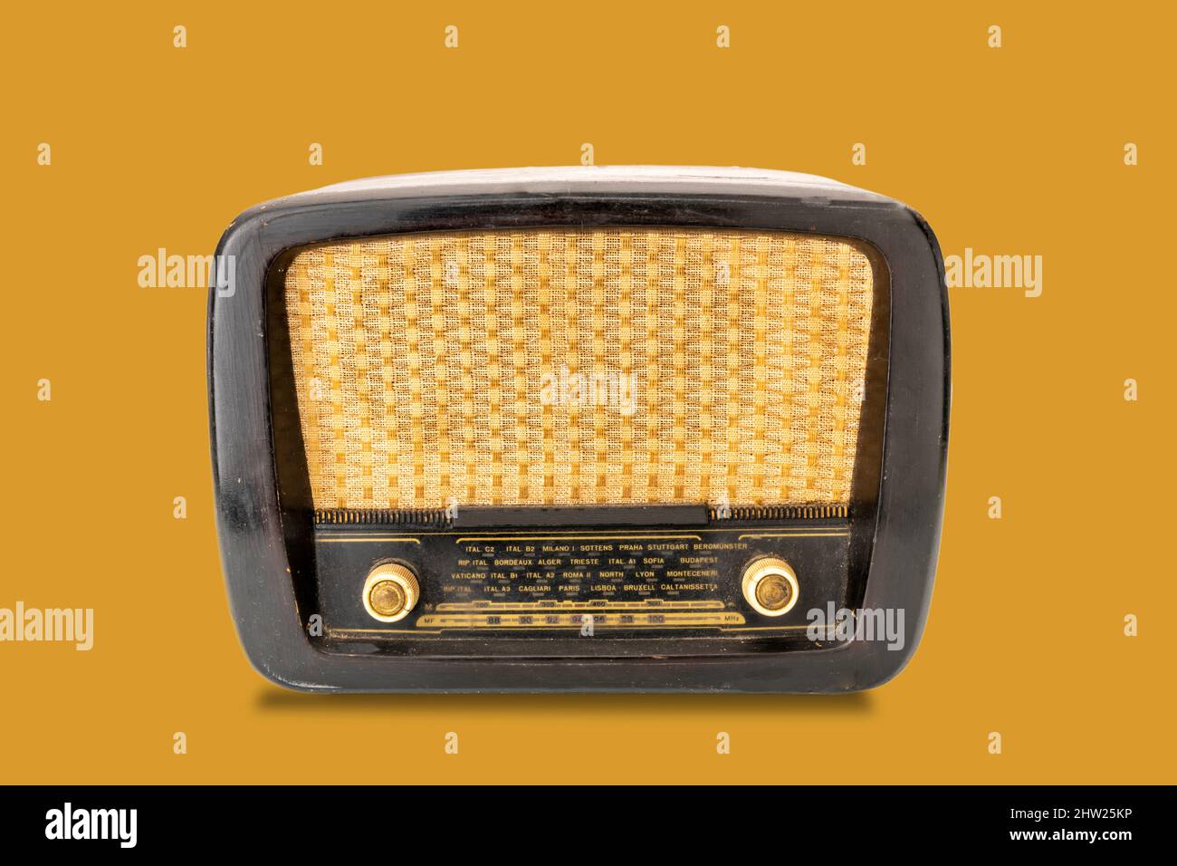 Vintage tube radio, or tuner of the postwar WW2, 1950s 20th century, isolated on yellow background Stock Photo