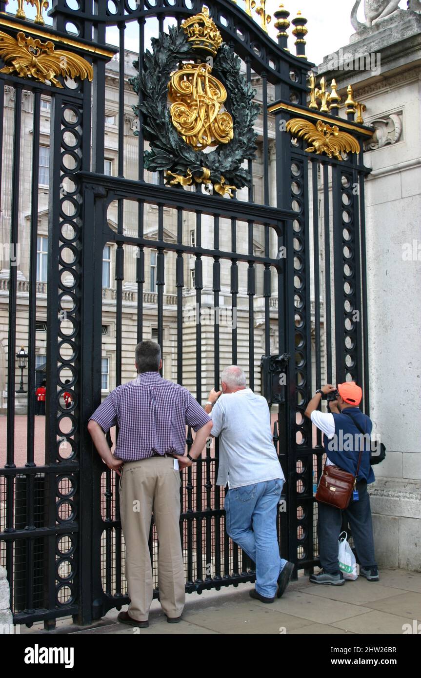 Tourists at the main Buckingham Palace gate in London, UK. Stock Photo