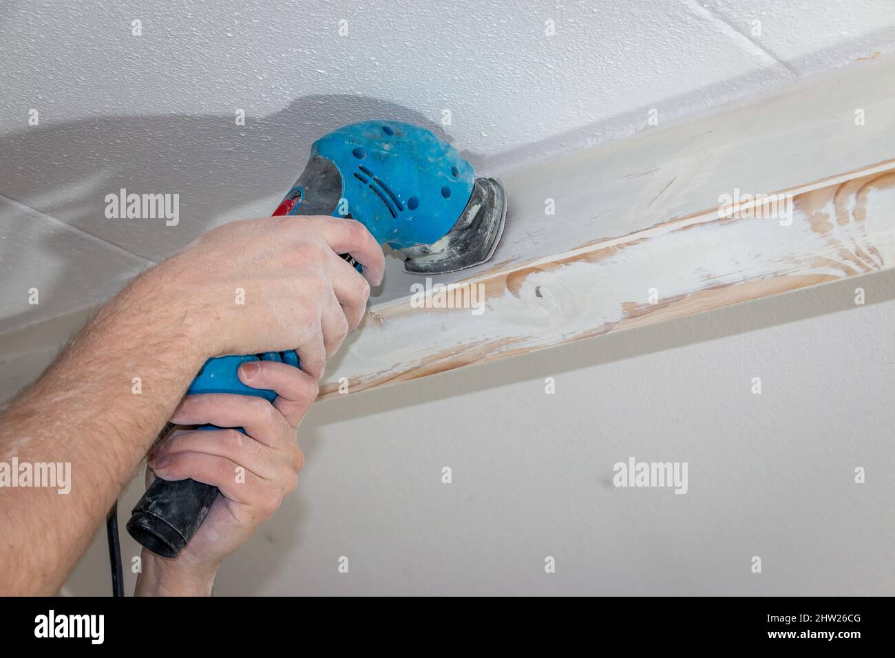 Sand the wooden ceiling beams with a sander and then paint them in a nice color, the Netherlands Stock Photo