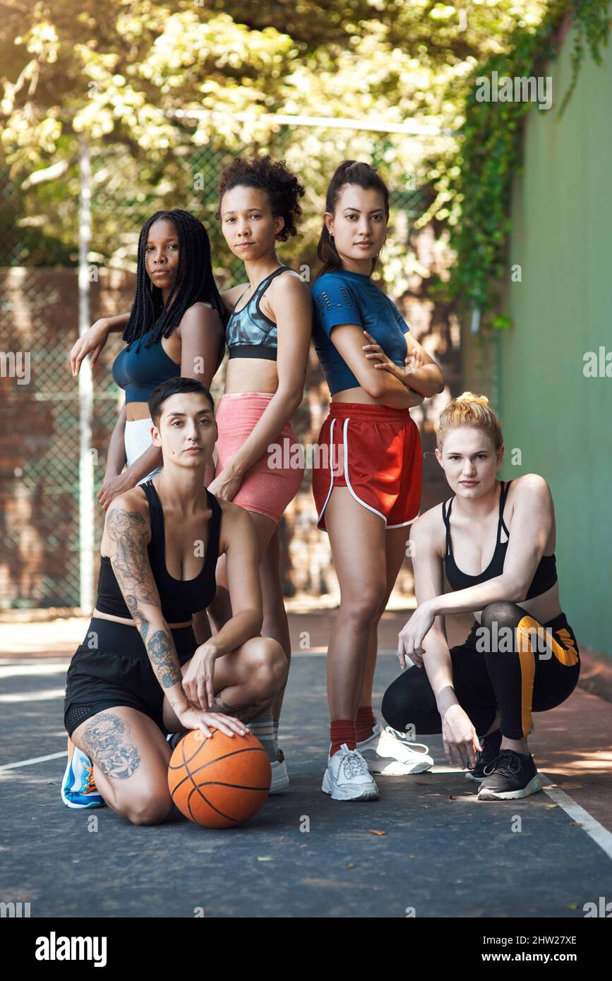 You wont find a better team. Full length portrait of a group of attractive young female athletes posing together on the basketball court. Stock Photo