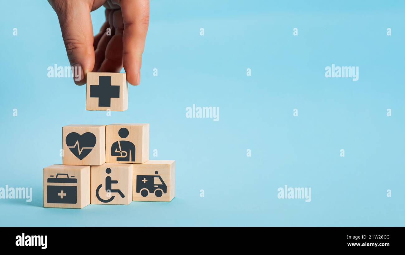 Hand arranging wood block stacking with the healthcare medical i Stock