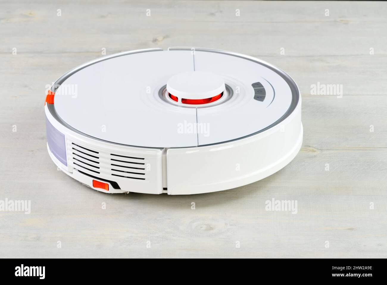 robot vacuum cleaner on the wooden floor cleaning the room. Smart
