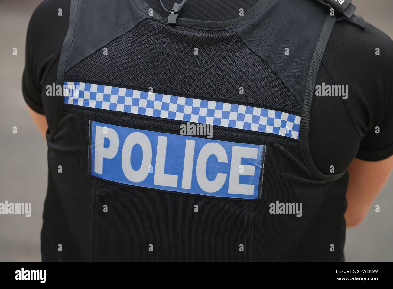 UK police officer on duty pictured from behind. Stock Photo