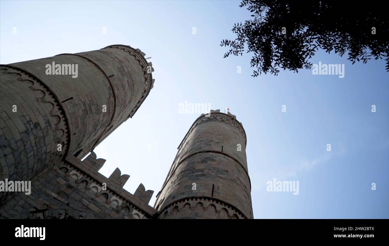 Bottom view of old fortress towers. Action. Two towers of old castle ...