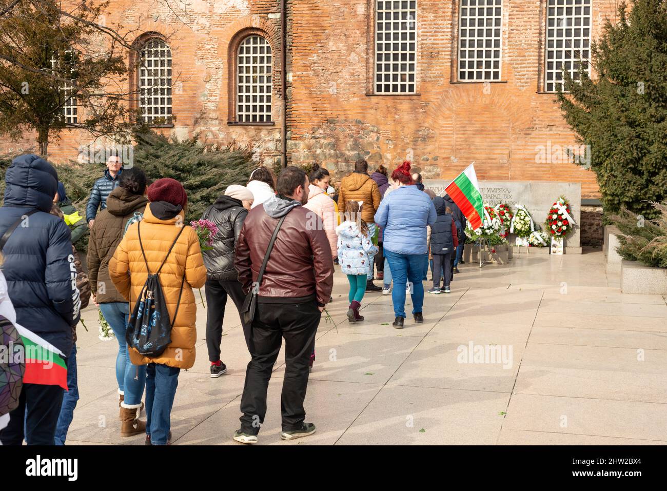 Sofia, Bulgaria. 03 March 2022. People waiting in line outside St. Sophia Church to put flowers at the Monument to the Unknown Warrior in respect and commemoration to the Bulgarian soldiers lost their lives in wars as Bulgarians celebrate the Bulgaria National Day. Stock Photo