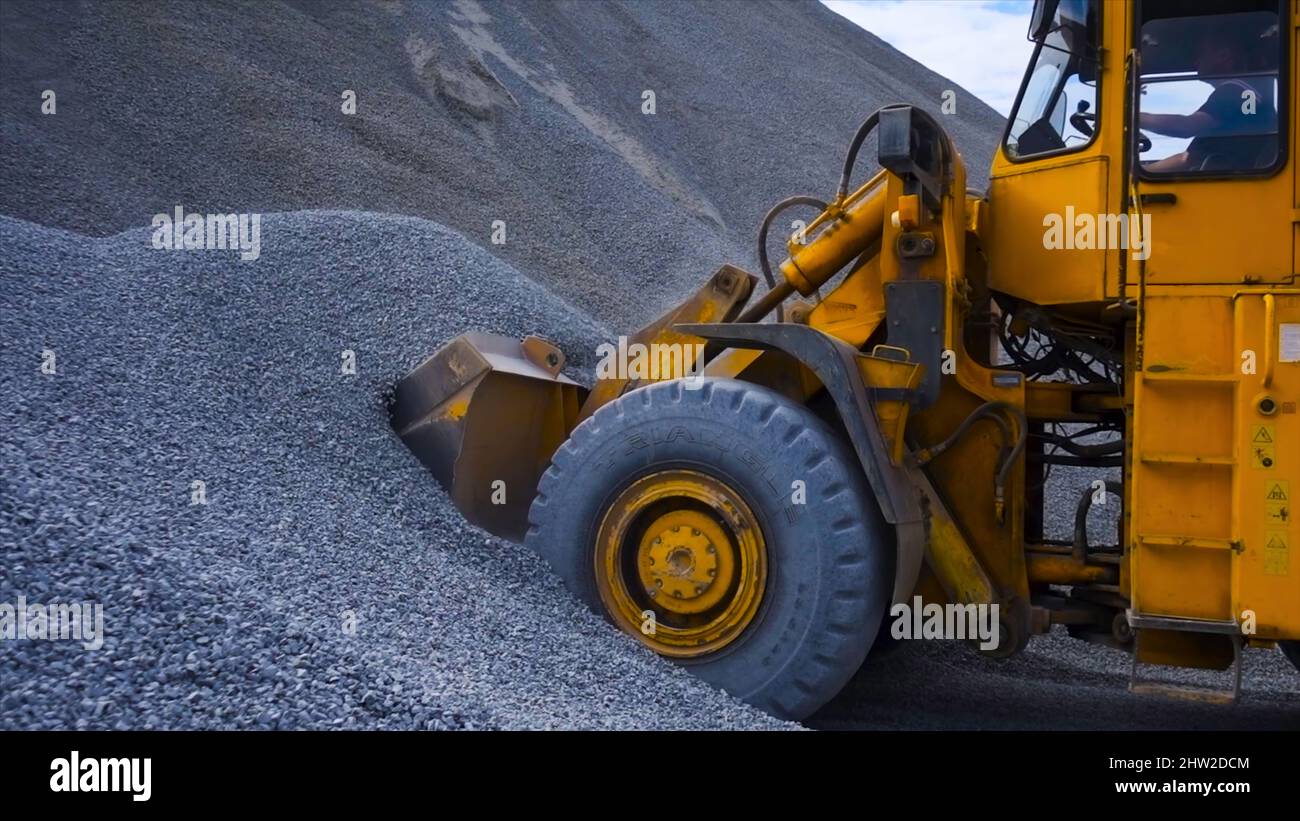 Tractor on construction site carries rubble. Stock footage. Tractor ...