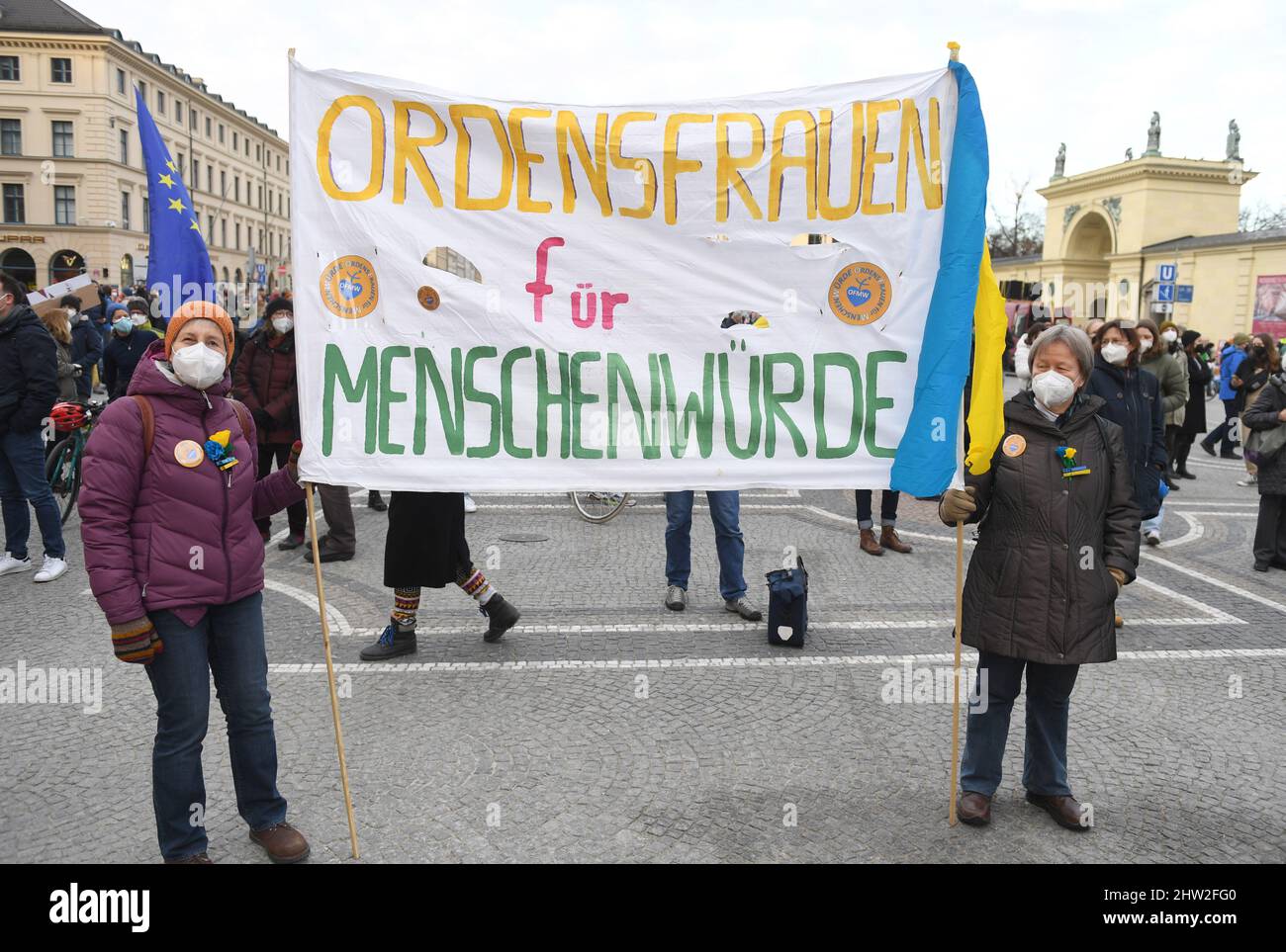 Munich, Germany. 03rd Mar, 2022. Demonstrators holding placards reading 'Women Religious for Human Dignity' stand in Odeonsplatz in the state capital during a worldwide protest by Fridays For Future against the war in Ukraine. Credit: Felix Hörhager/dpa/Alamy Live News Stock Photo