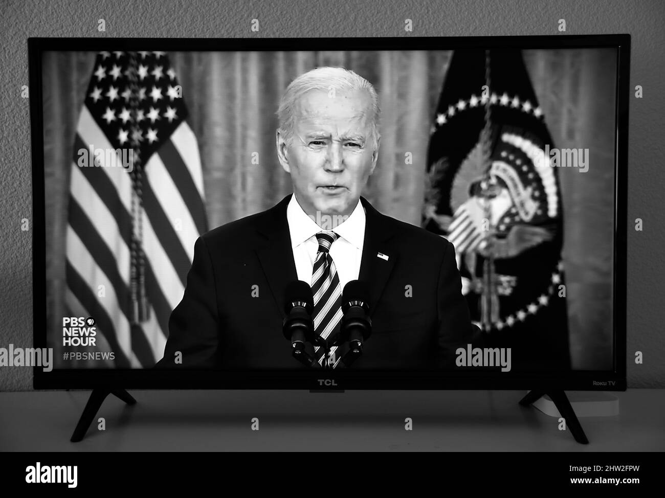 A TV screenshot of US President Joseph Biden delivering a speech carried by PBS television after the Russian military invaded Ukraine. Stock Photo