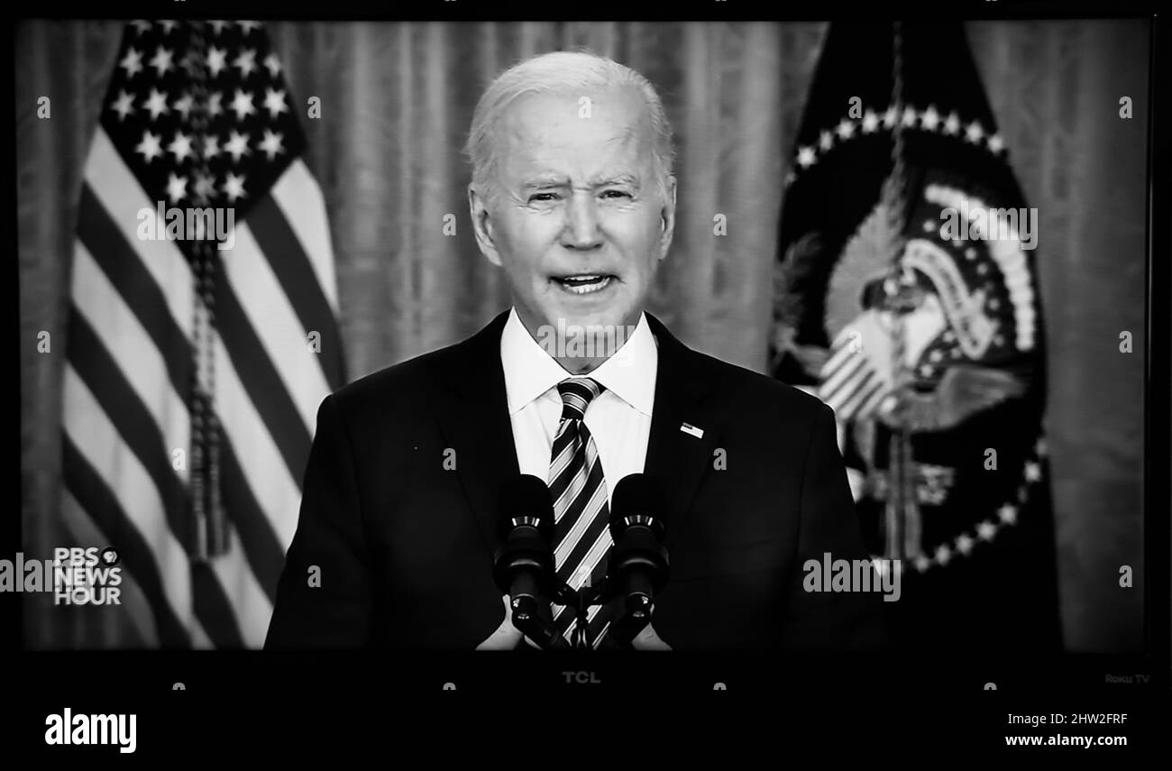 A TV screenshot of US President Joseph Biden delivering a speech carried by PBS television after the Russian military invaded Ukraine. Stock Photo