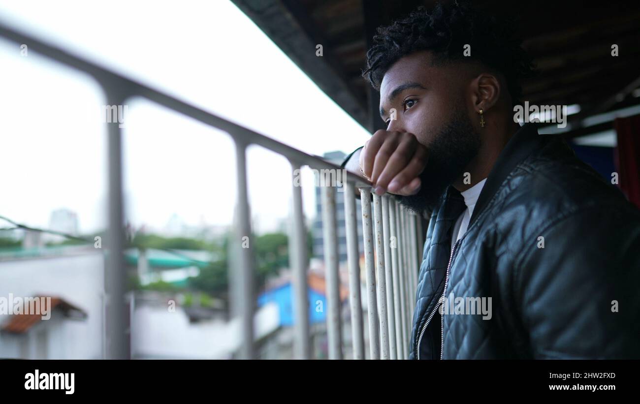 A pensive black man standing on balcony thinking about life Stock Photo - Alamy A pensive black man standing on balcony thinking about life Stock Photo - Alamy