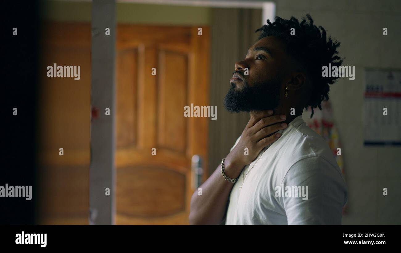 Worried black man standing window hi-res stock photography and images ...