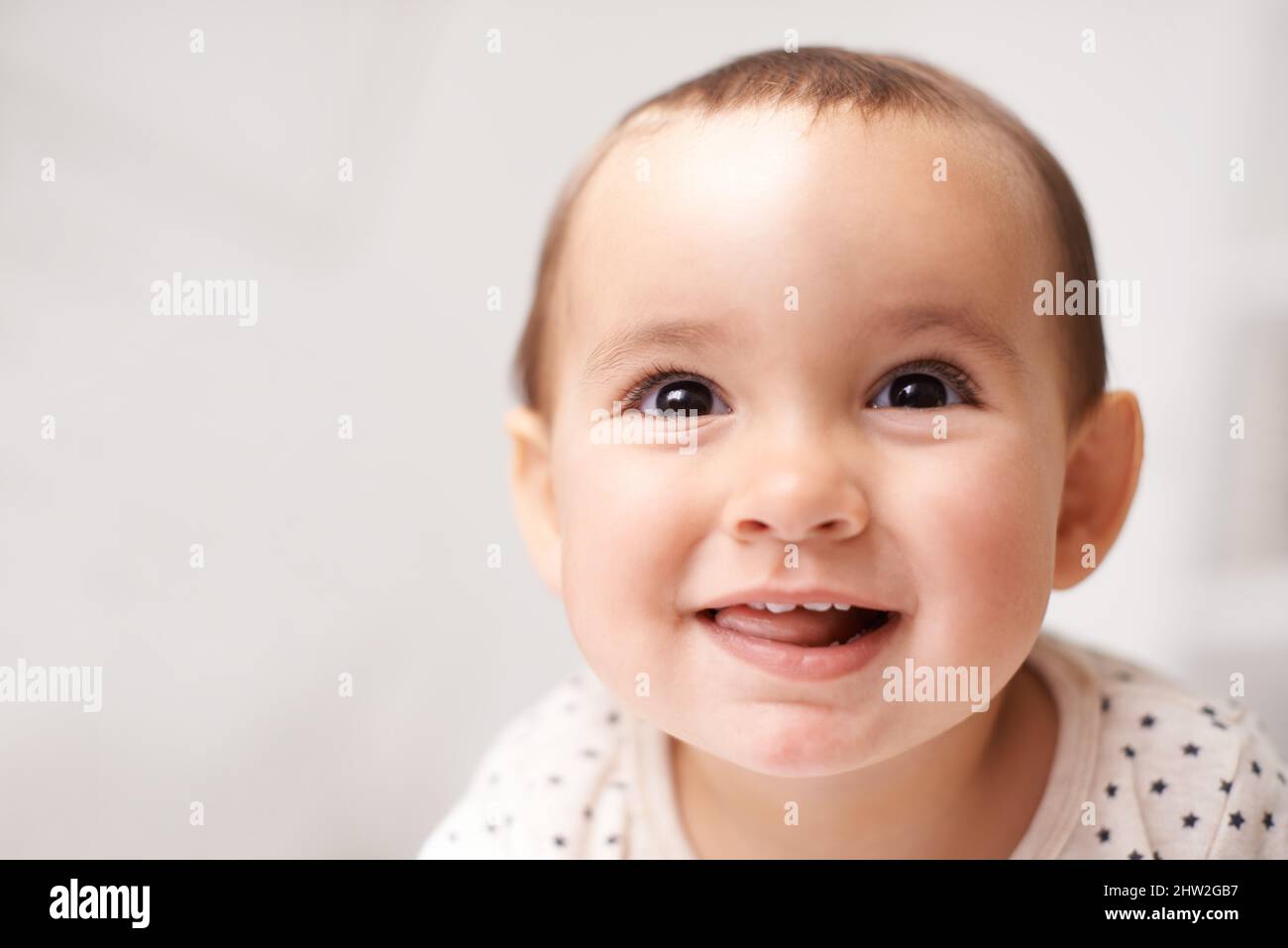 Eyes lit up with curiousity. Cropped shot of an adorable baby girl at