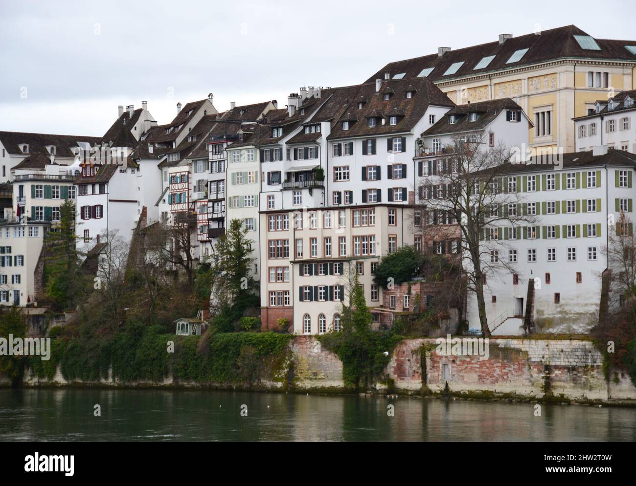 Old buildings on the riverside during sunset in Basel, Switzerland Stock Photo