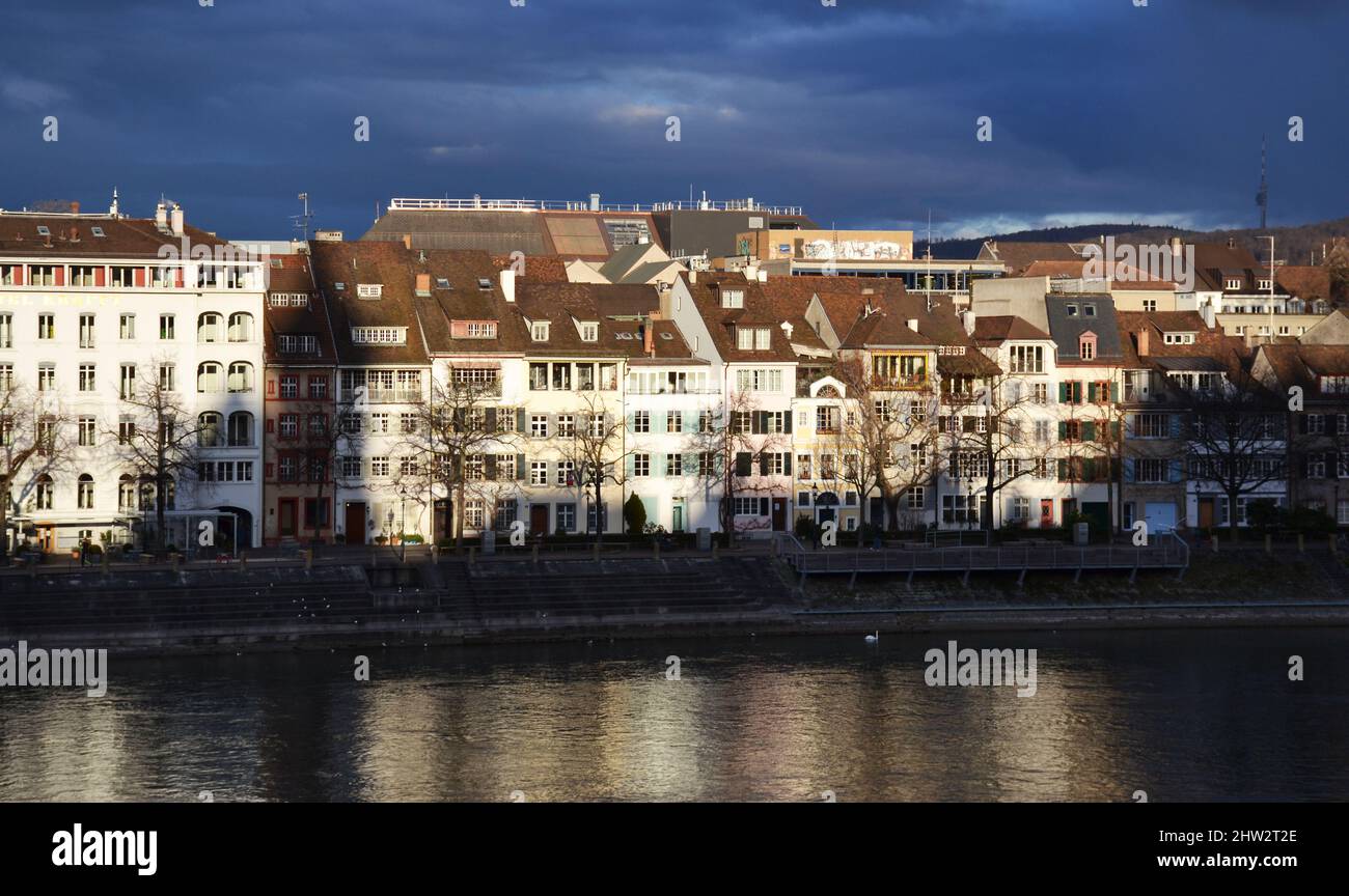 Old buildings on the riverside during sunset in Basel, Switzerland Stock Photo