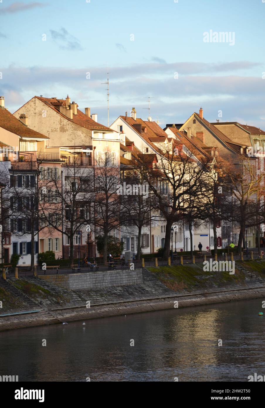 Old buildings on the riverside during sunset in Basel, Switzerland Stock Photo