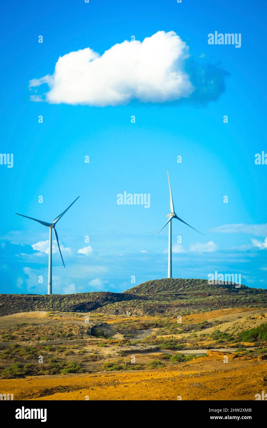 Wind turbines in the country side against a blue sky with clouds ...
