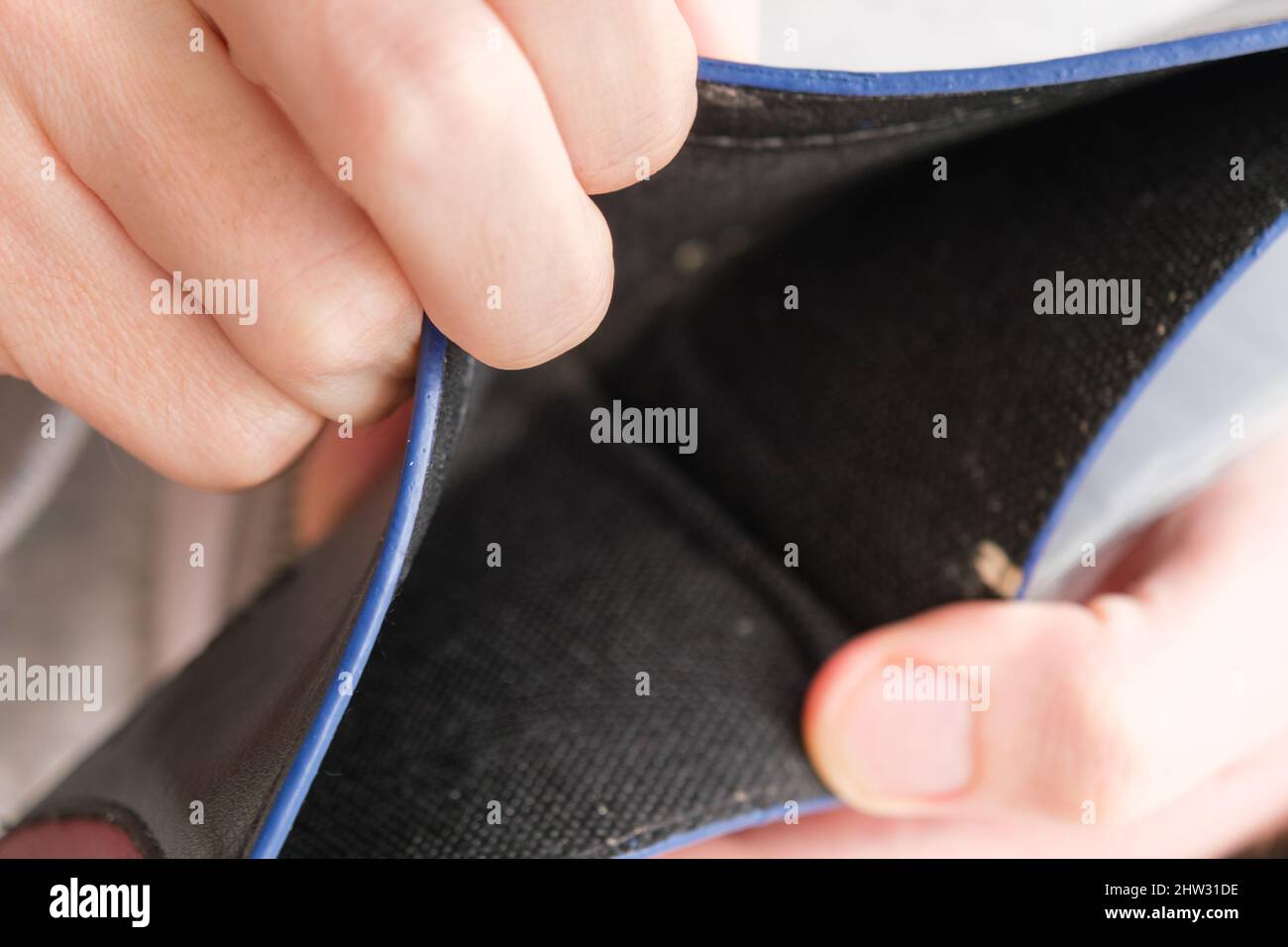 Man hand showing an open empty wallet close up. Poverty, cost control ...