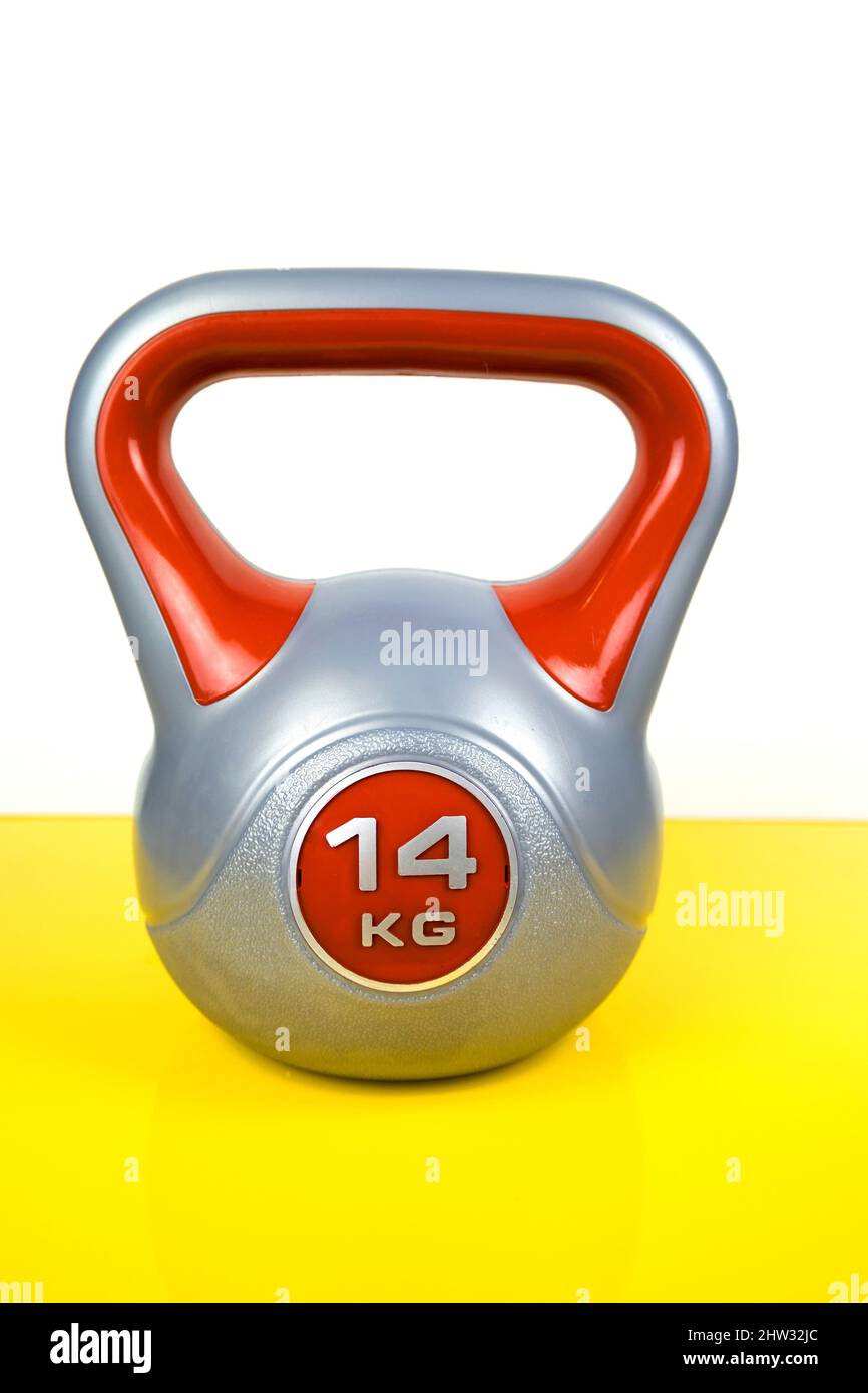 a sports kettlebell on a yellow background. Healthy lifestyle Stock Photo