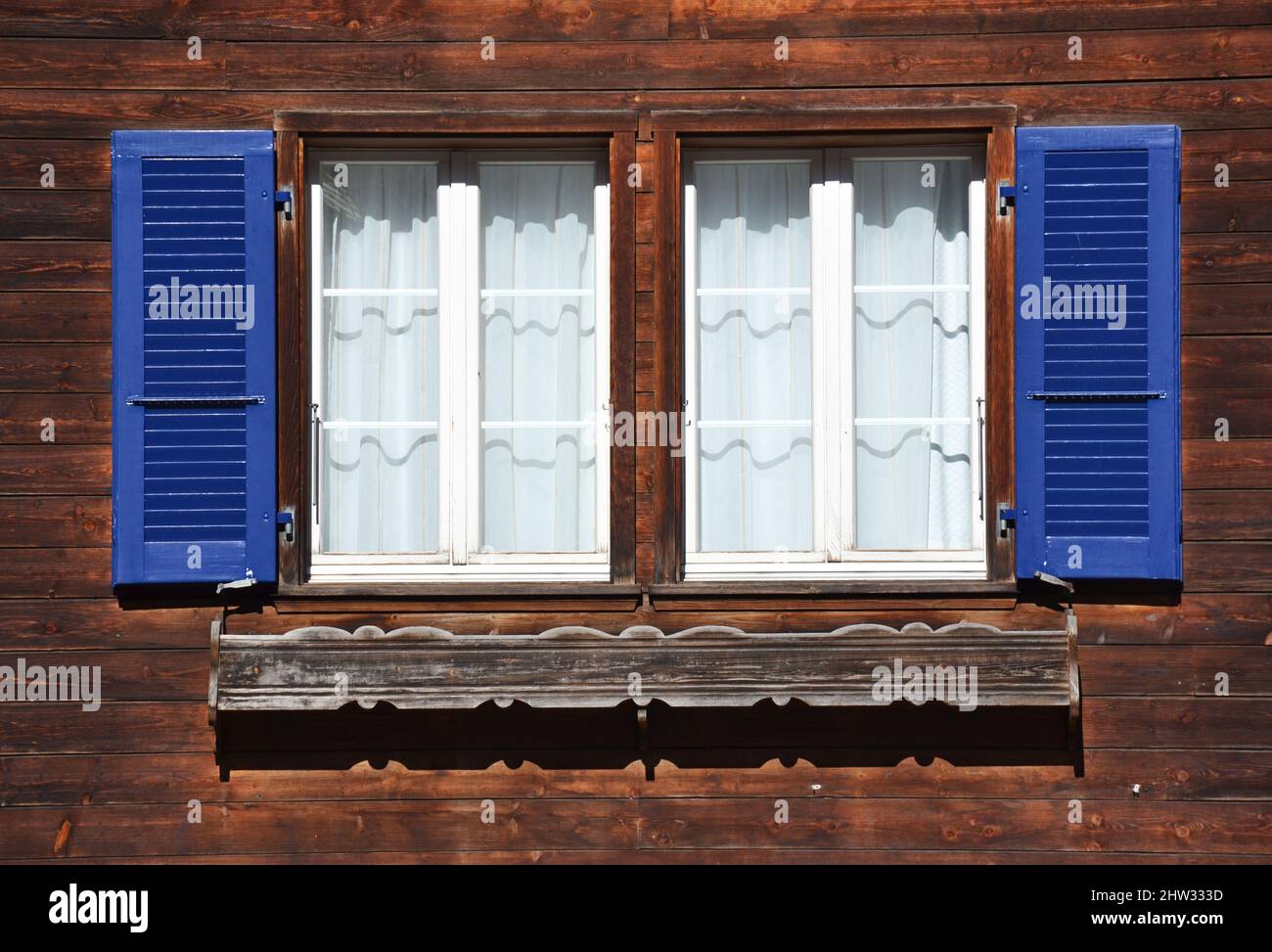 Old style open windows of a house in a swiss village Stock Photo