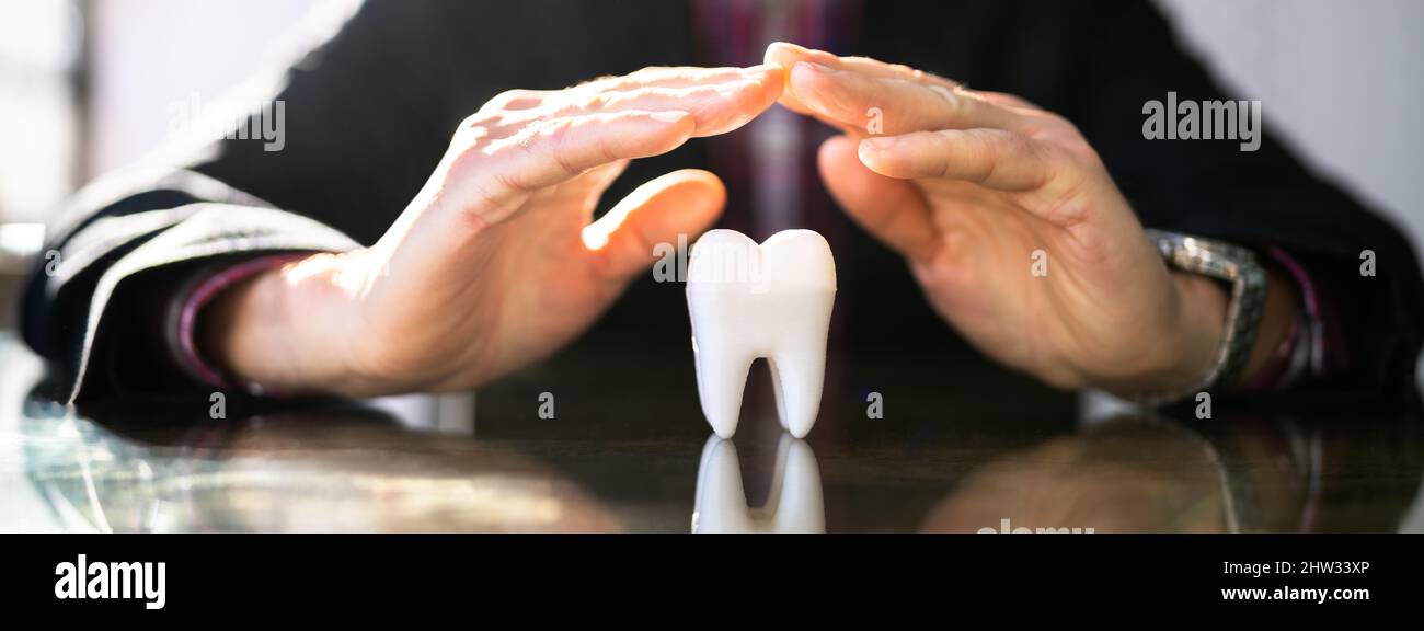 Dental Insurance. Protecting Teeth Enamel. Tooth Implant Stock Photo