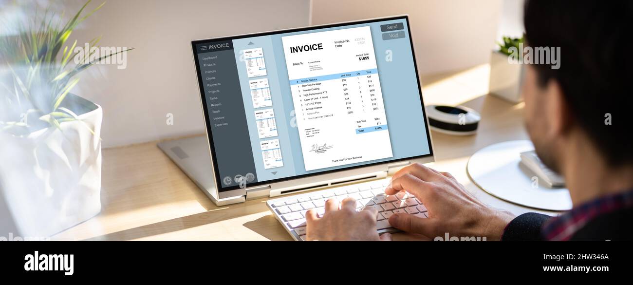 Accountant Using Online E Invoice Software On Tablet Stock Photo