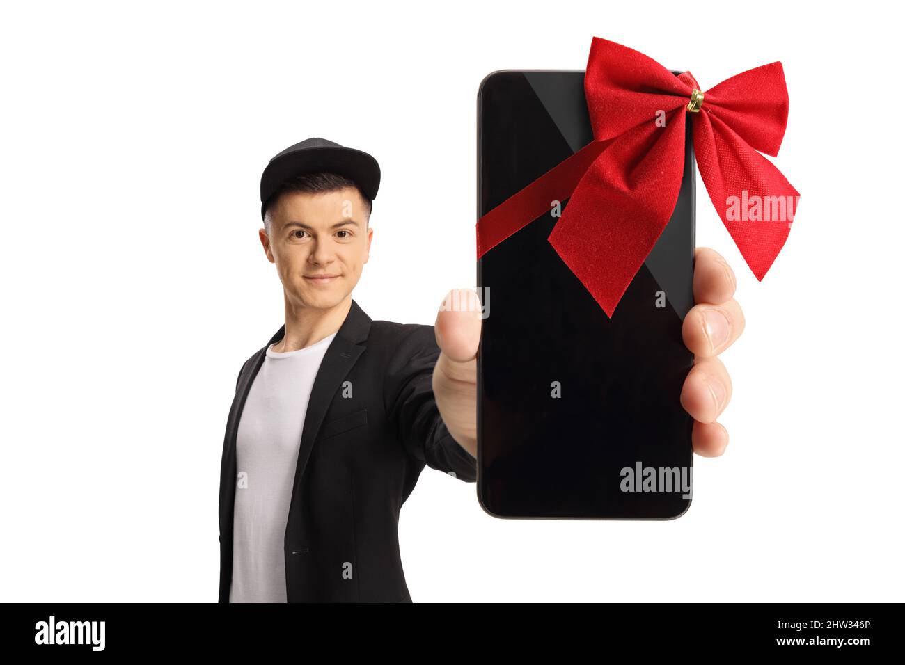 Full length portrait of a fashionable guy showing a smartphone with red ribbon in front of camera isolated on white background Stock Photo