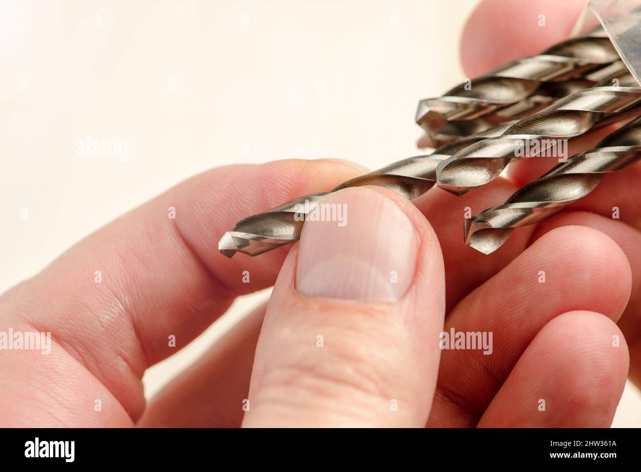 Installing a drill bit in a drill, hands take a drill and install it in a cordless drill chuck
