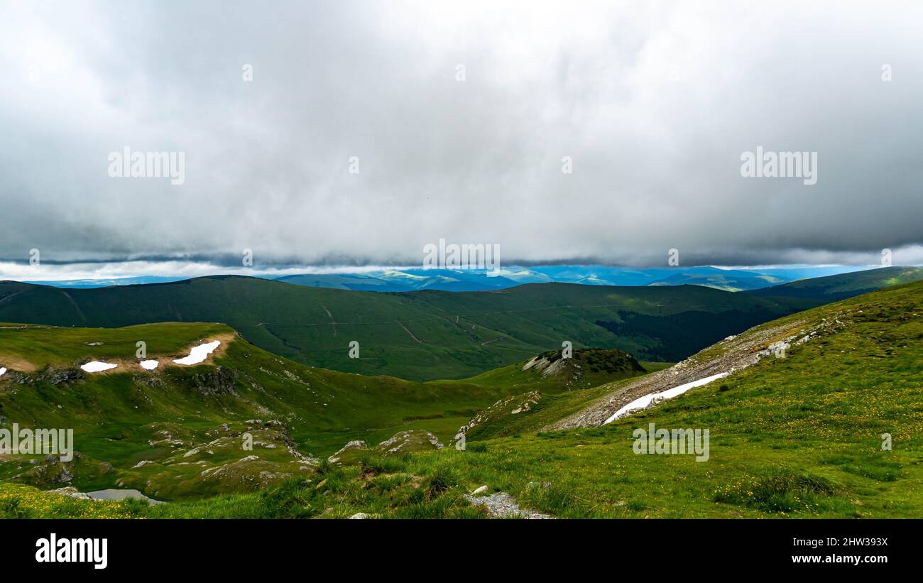Panoramic view of beautiful green mountains under the cloudy sky Stock ...