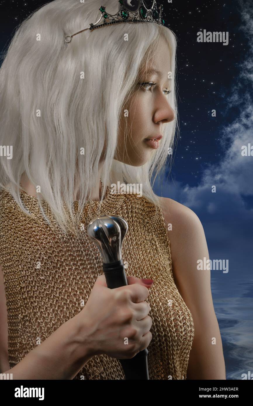 Beautiful Blonde Sword wielding viking warrior female profile side view Stock Photo
