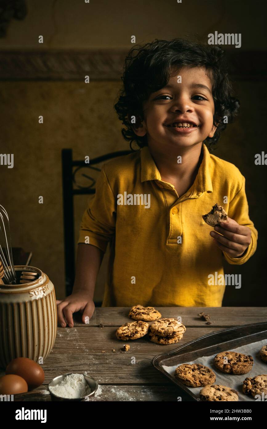 cute little boy holding chocolate chip cookie Stock Photo