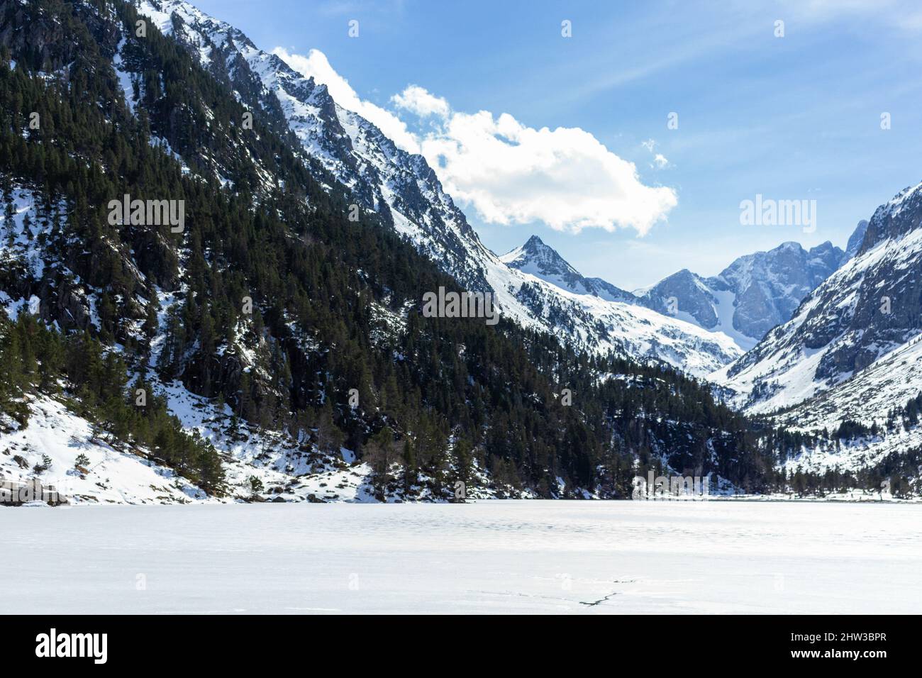 Frozen Gaube Lake in the French Pyrenees with the mountain Vignemale in the background, France Stock Photo