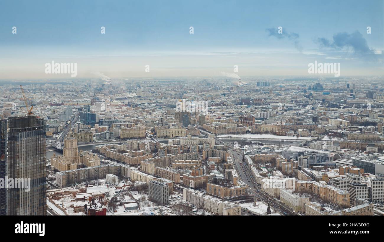 View of the big city from above. Metropolis under high blue sky with white clouds. Top view of Moscow on a winter day, aerial photography Stock Photo