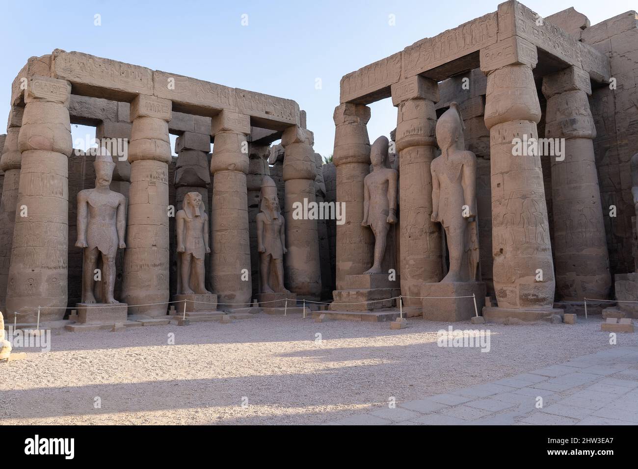 Columns and statues in the courtyard of Ramses II of the Luxor Temple ...