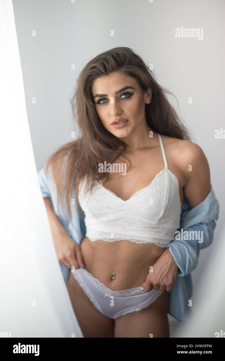 Attractive sexy brunette in white lingerie and denim shirt posing provocatively, near a grey wall,studio shot. Portrait of sensual woman Stock Photo - Alamy Attractive sexy brunette in white lingerie and denim shirt posing provocatively, near a grey wall,studio shot. Portrait of sensual woman Stock Photo - Alamy