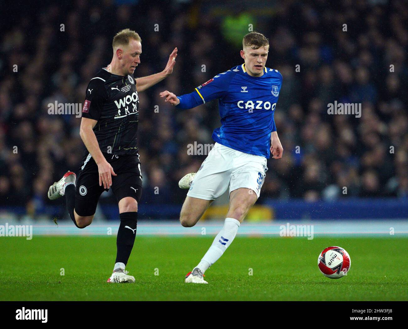 Boreham Wood's Scott Boden (left) and Everton's Jarrad Branthwaite battle for the ball during the Emirates FA Cup fifth round match at Goodison Park, Liverpool. Picture date: Thursday March 3, 2022. Stock Photo