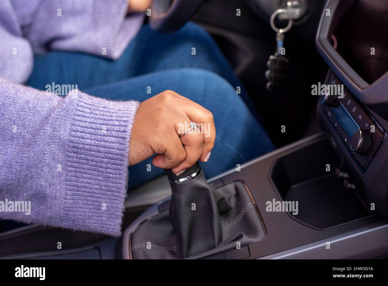 Close up Young woman hand on manual gear shift, shifting gearbox in car