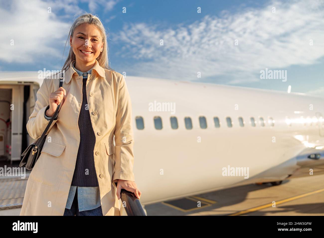 Woman boarding aircraft hi-res stock photography and images - Alamy