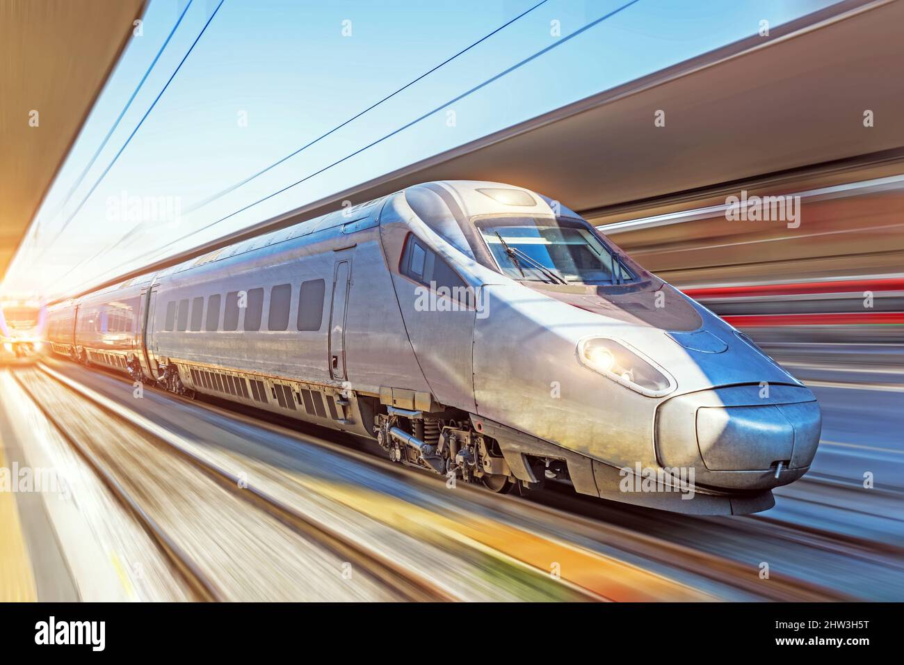 Modern high speed train on a clear day with motion blur at the city ...