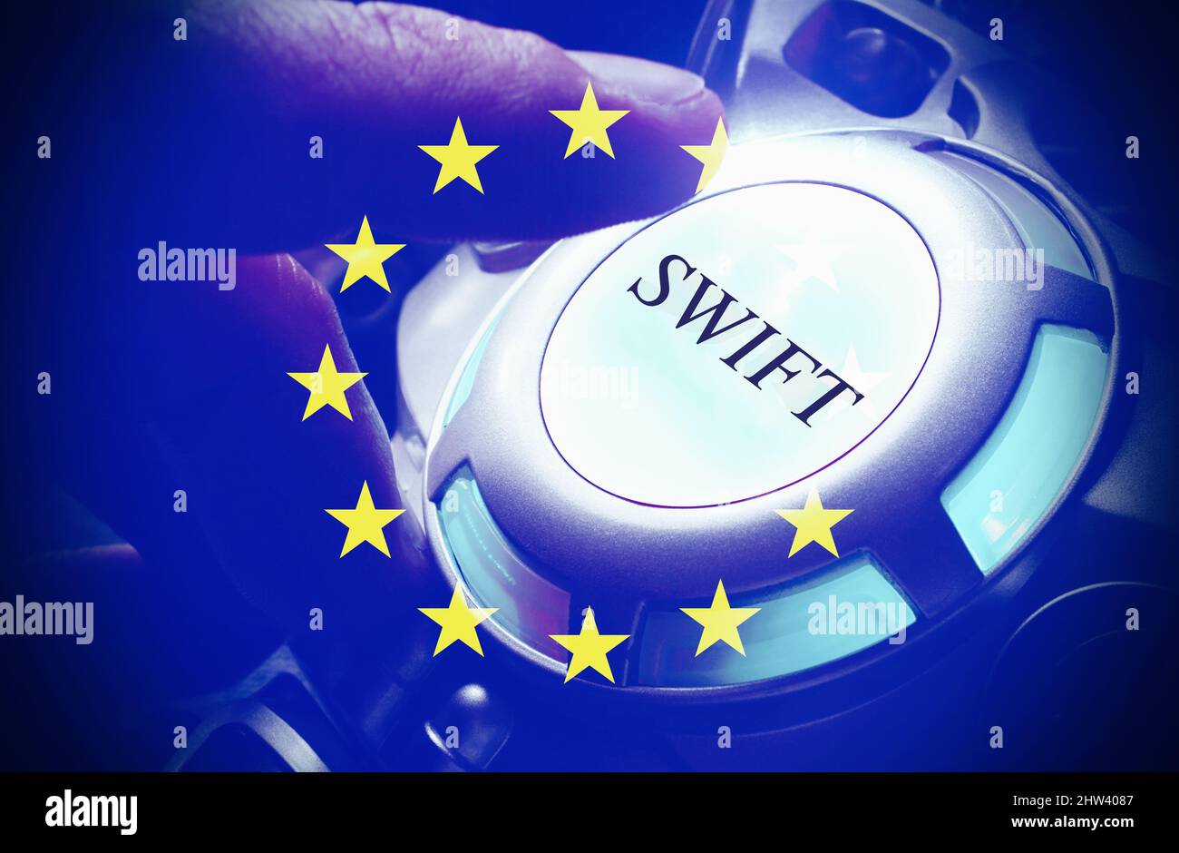 Human hand pushing the Swift button , with the European Flag, concept of Russian sanctions . Stock Photo