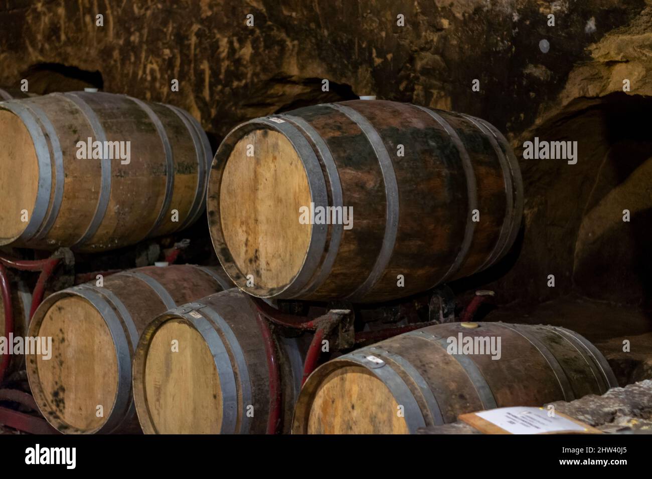 Medieval underground wine cellars with old red wine barrels for aging