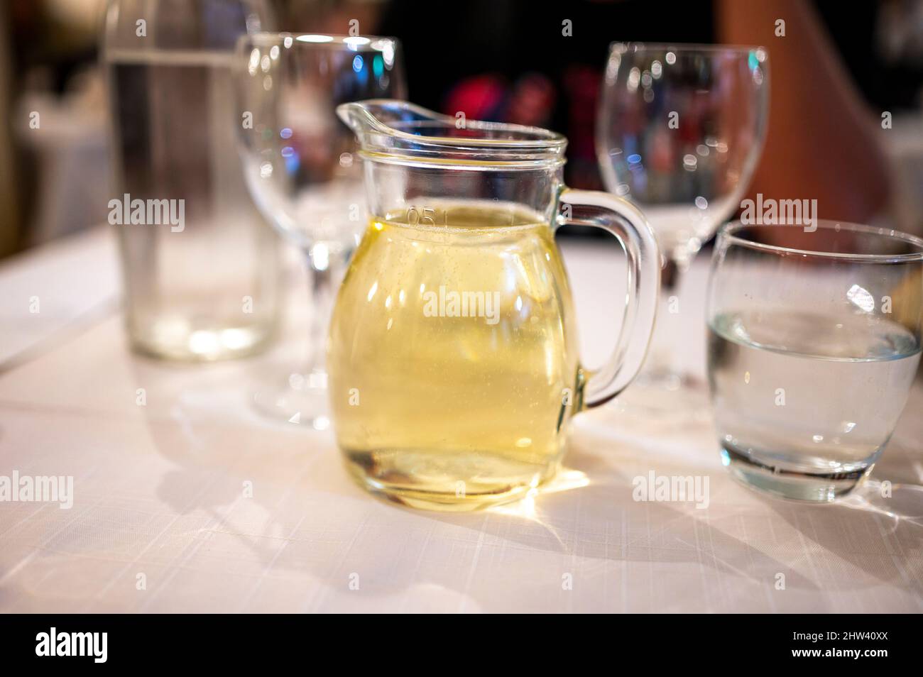 Italian white house wine served in pitcher with two glasses