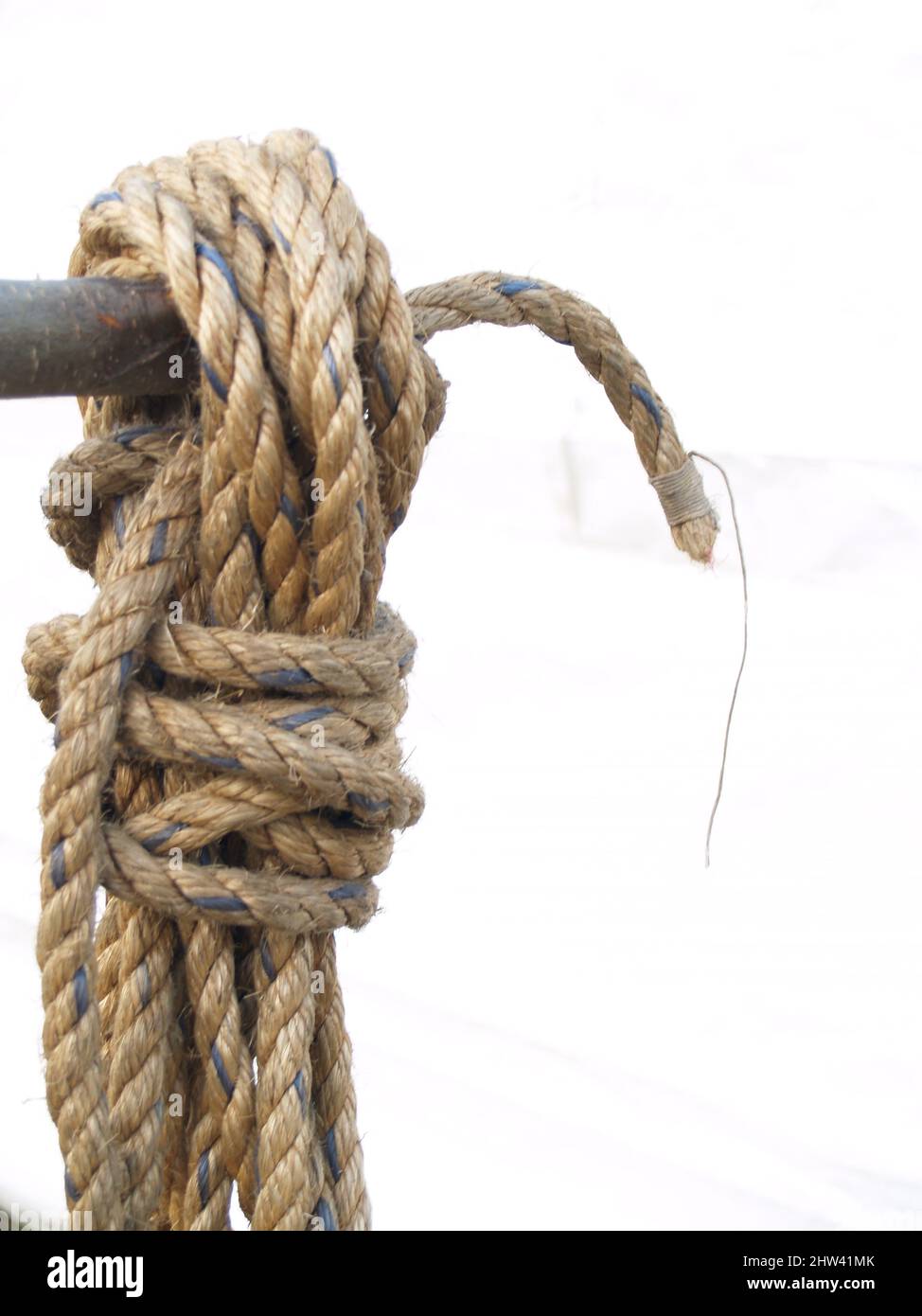 Coiled Rope hanging on a pipe isolated on whiite Stock Photo Alamy