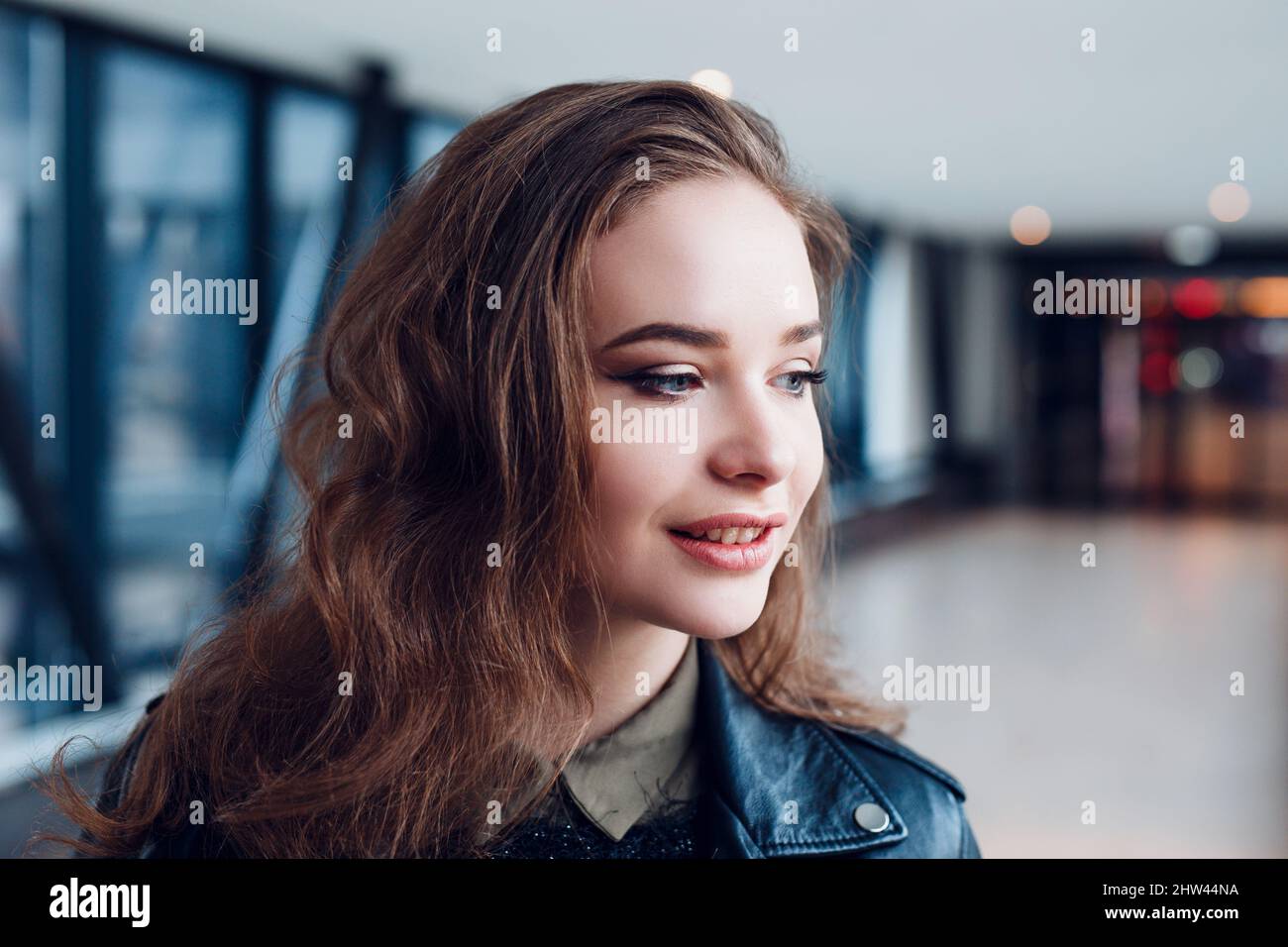 Close-up portrait of young stylish woman with curly hair. Student girl Stock Photo