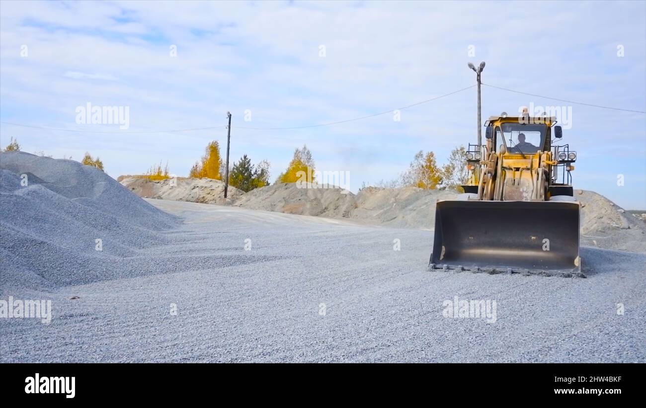 Tractor on construction site carries rubble. Stock footage. Tractor