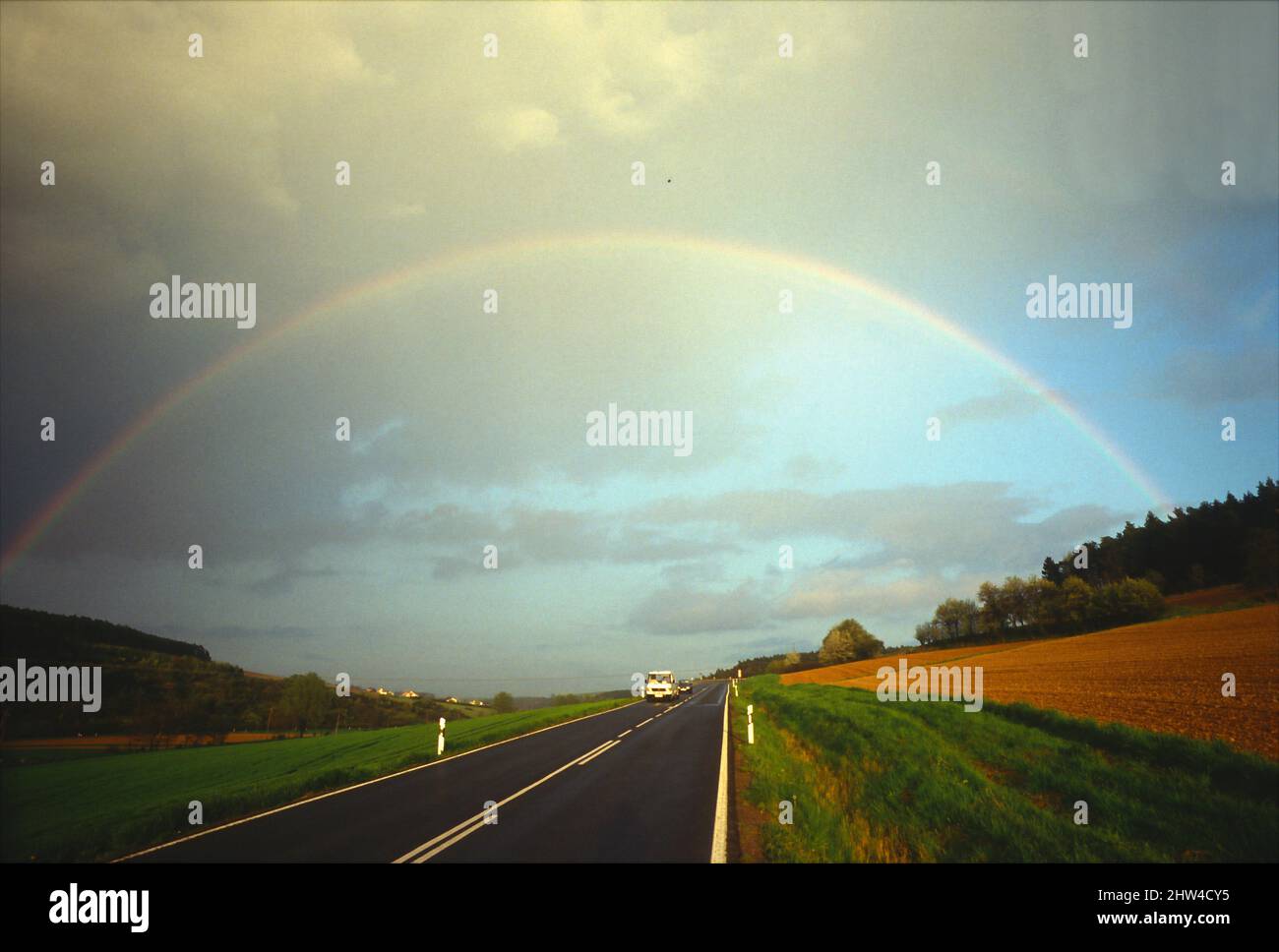 Highway with rainbow in Bavaria, Germany. Stock Photo