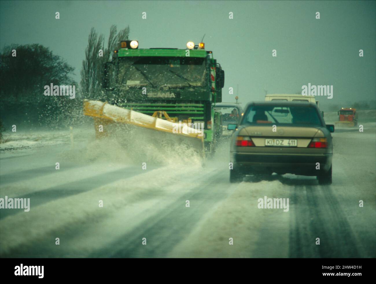 Snow shovel truck clearing a road in winter. Stock Photo